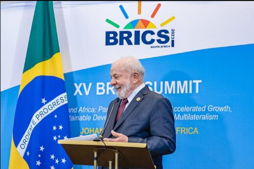 Brazilian President Lula da Silva speaking at the Rio 2025 summit with summit banner behind him.