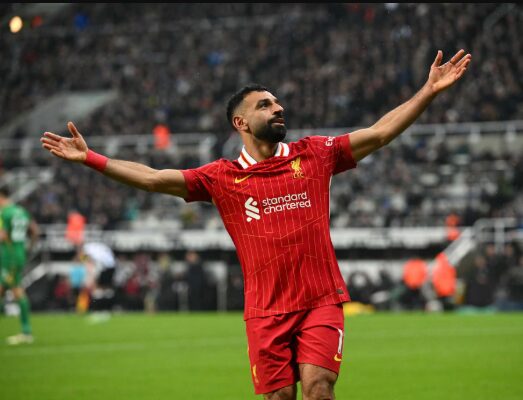 Graphic illustration of Mohamed Salah as the Egyptian King in a red Liverpool jersey with arms outstretched against a UK map background.