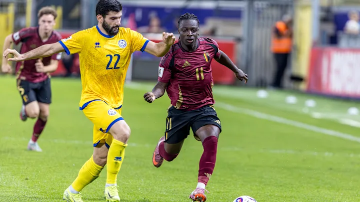 Belgium and Kazakhstan football players competing on the field