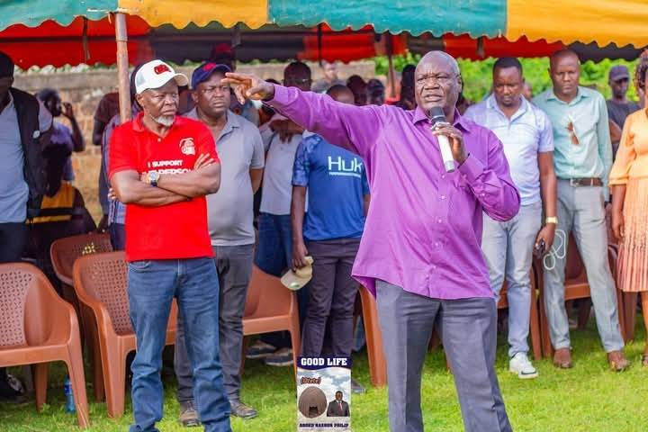 Deputy Governor Oyugi Magwanga standing with Philip Aroko during Kasipul by-election campaign event.